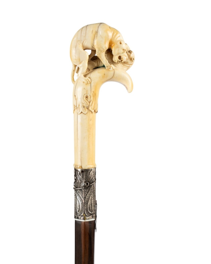 19TH C. ENGLISH TWO FIGHTING DOGS HANDLE CANE: English, circa 1880. Walking cane with carved handle depicting two dogs in a fight, with engraved inscription "With the Compliments of the Season to the Hon. Wm. L. Helfenstein", embossed silver colla