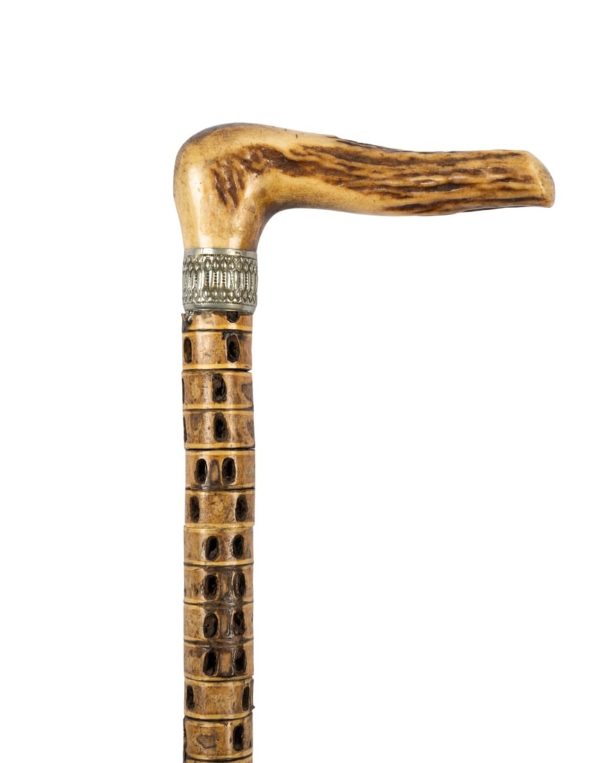 19TH C. DANISH SHARK VERTEBRA WALKING CANE: Danish, circa 1890. Walking cane with handle of carved and stained bone resembling stag horn on silver collar, shark vertebra shaft mounted on metal rod, and metal ferrule. Approximate measurements: h