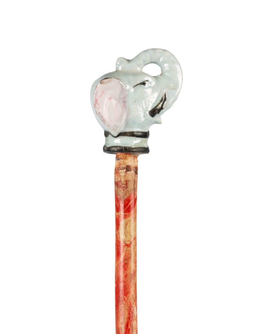 AMERICAN PORCELAIN ELEPHANT CIRCUS CANE, C. 1930: American, circa 1930. Walking cane with painted porcelain elephant handle, painted maple wood shaft, metal ferrule, typically given as circus prize. Approximate measurements: length: 37.25"