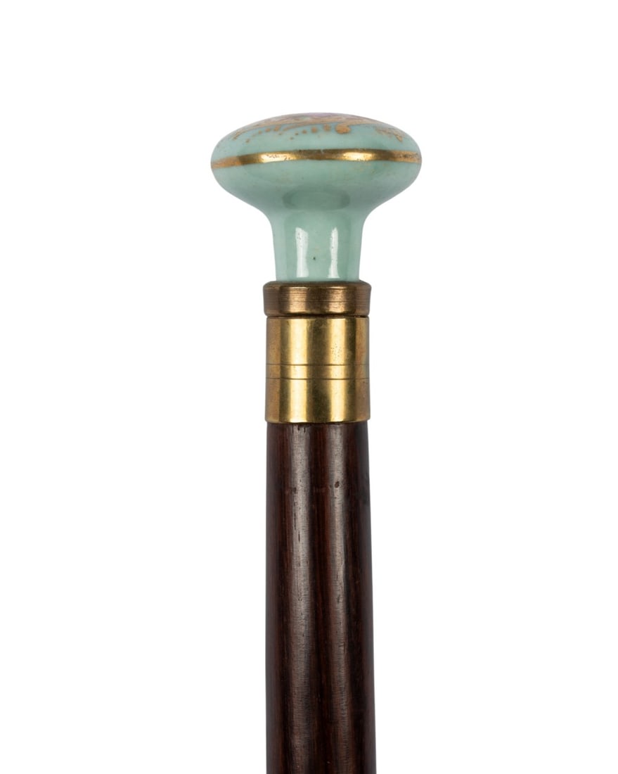 FRENCH LIMOGES PORCELAIN WALKING CANE, C. 1910: French, circa 1910. Walking cane with Limoges porcelain knob handle hand-painted with a gentleman courting a lady, brass collar, nicely stained Malacca shaft, and metal ferrule. Approximate measuremen