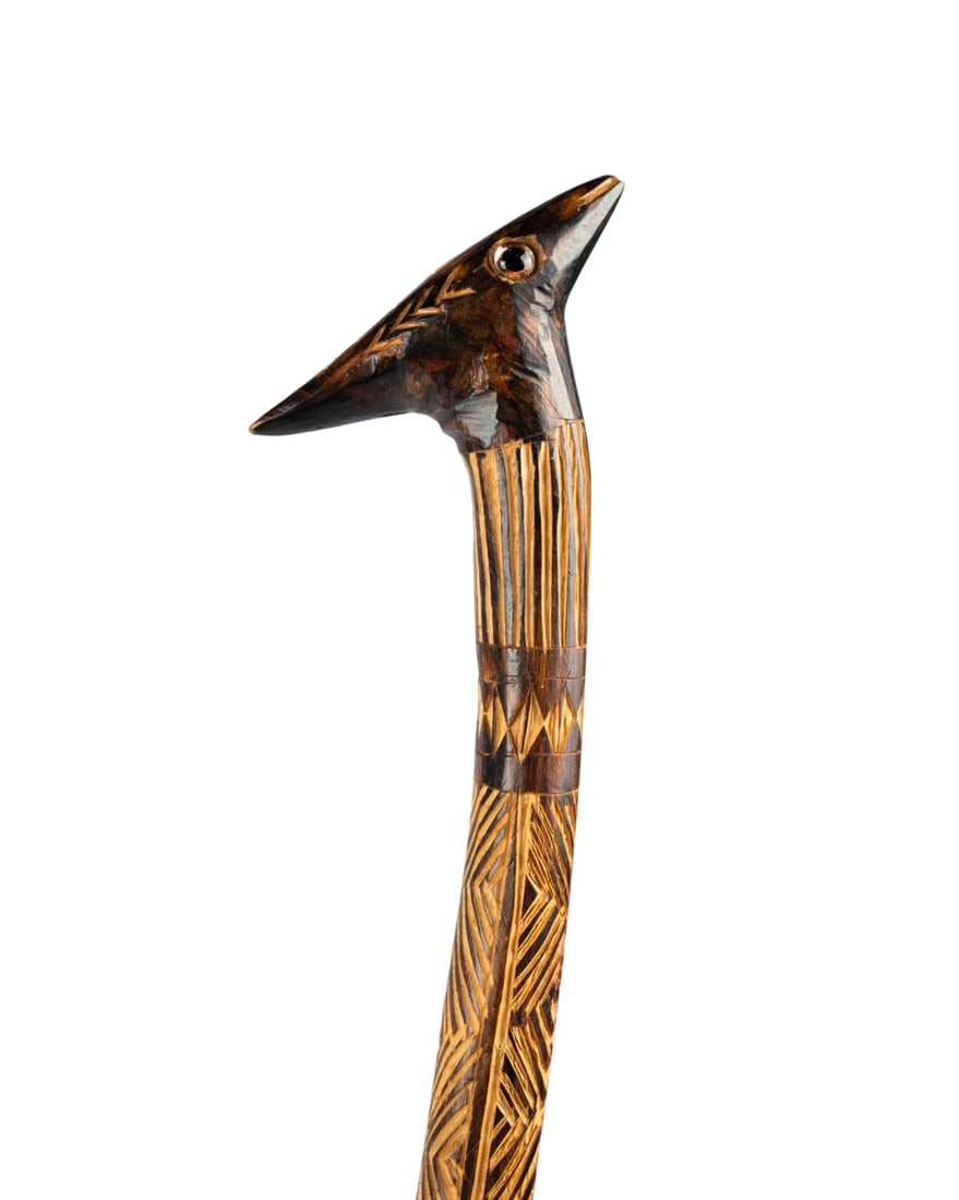 ENGLISH CARVED BIRD WALKING CANE, C. 1910: English, circa 1910. Walking cane with carved bird?s head handle with inset glass eyes, oak handle and shaft, repeating carved zigzag pattern along the shaft, and metal ferrule. Approximate