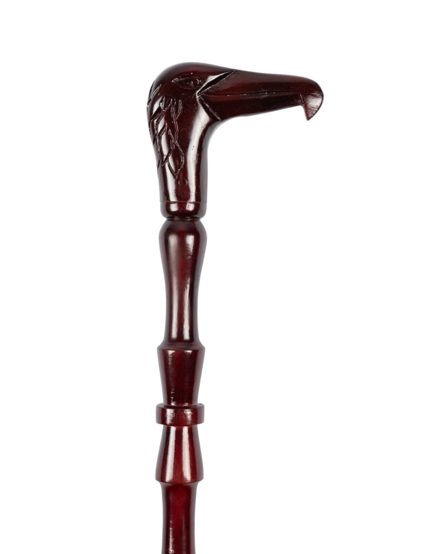 WALKING CANE WITH CARVED WOOD BIRD HANDLE, C. 1910: Continental, circa 1910. Walking cane with carved wood bird?s head handle with beak forming top, turned and carved upper quarter of shaft, handle and shaft stained reddish brown, without ferrule. 