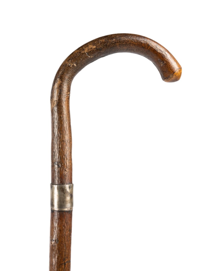 19TH C. AMERICAN HEAVY CROOK HANDLE WALKING CANE: American, circa 1890. Walking cane with slightly crook natural branch handle, silver collar, and metal ferrule. Approximate measurements: length: 37.25"