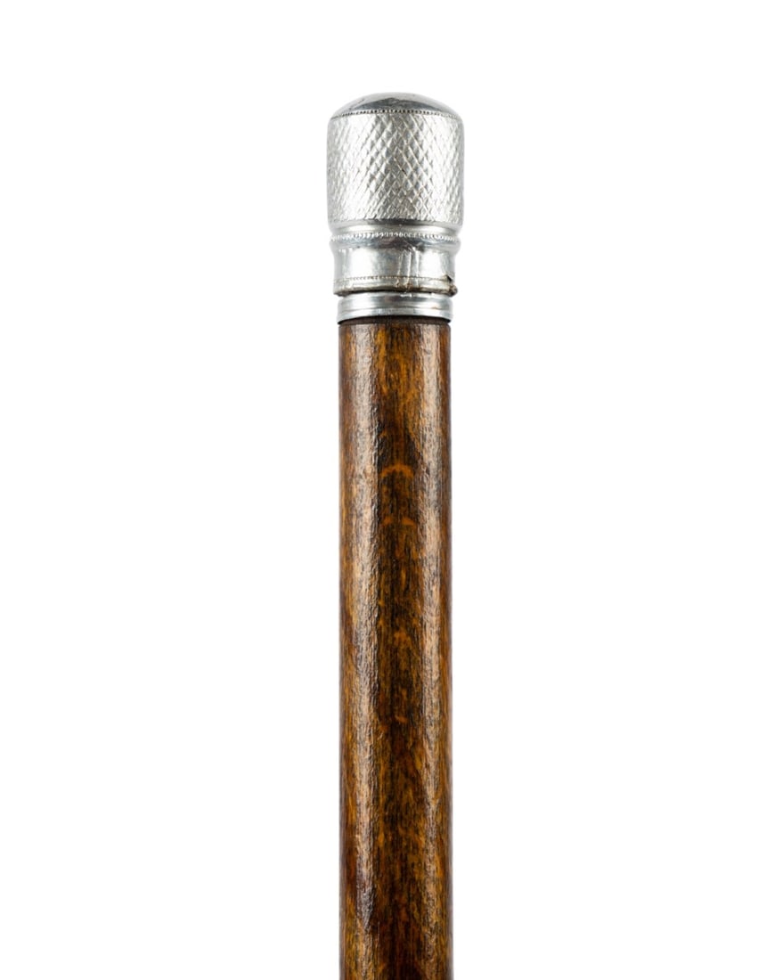 19TH C. ENGLISH SILVER THIMBLE WALKING CANE: English, circa 1880. Walking cane with silver thimble handle, oak shaft with two metal rings, and brass ferrule. Approximate measurements: length: 33.25"