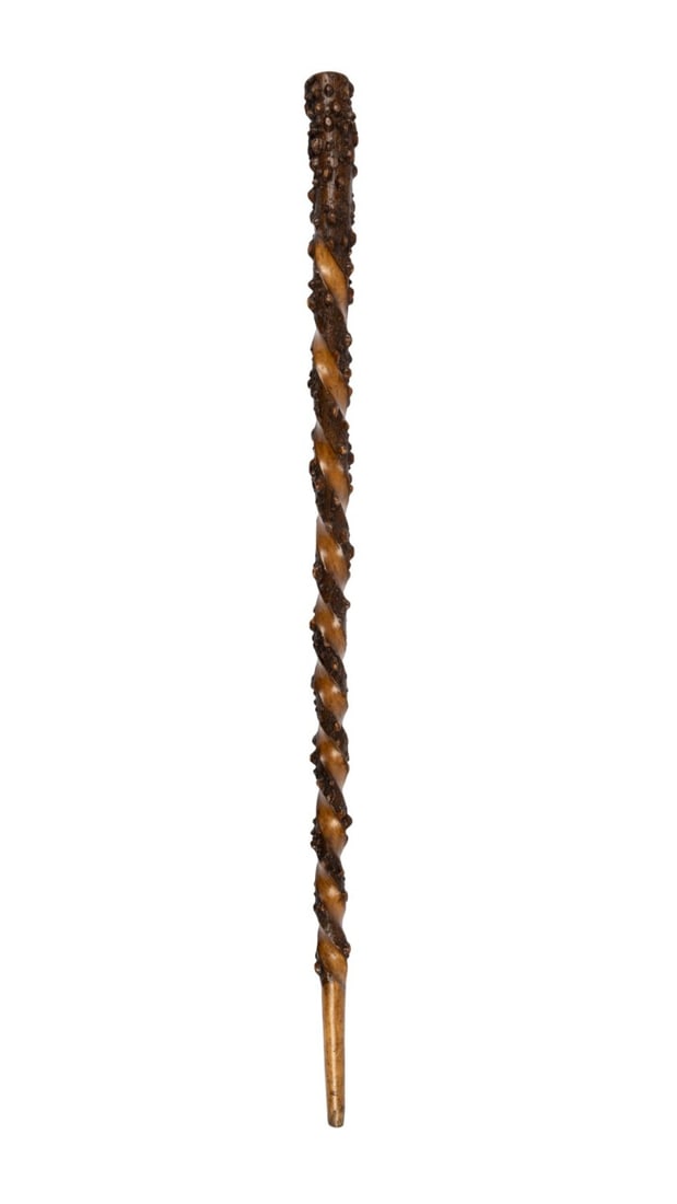 19TH C. ENGLISH FOLK ART WALKING CANE: English, circa 1880. Folk art walking cane of carved natural wood with rough handle, twisted carved shaft, and without ferrule. Approximate measurements: length: 36"