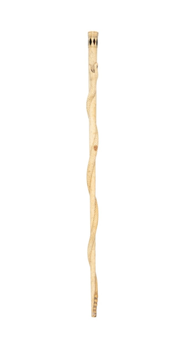 INLAID CARVED BONE SNAKE WALKING CANE, C. 1900: Continental, circa 1900. Small cane or swagger stick of carved bone with a snake wrapped along the length and inlaid glass pieces in a diamond pattern at the top. Approximate measurements: length: 20.