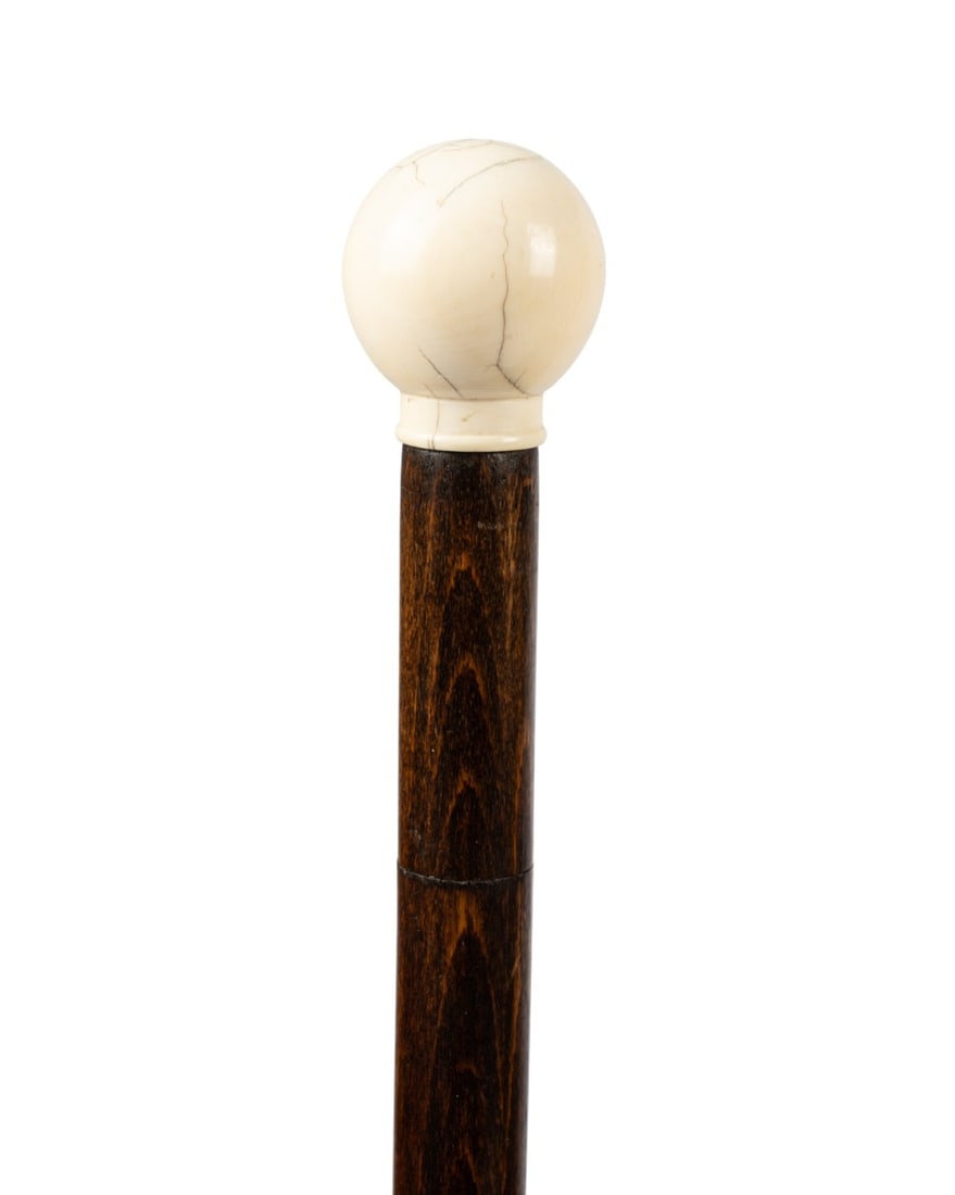 19TH C. FRENCH DOG MEASURING CANE: French, circa 1870. Dog measuring cane with polished bone ball handle, pull out metric measuring stick for dog length, stained oak shaft, and steel ferrule. Approximate measurements: length: 34.25"