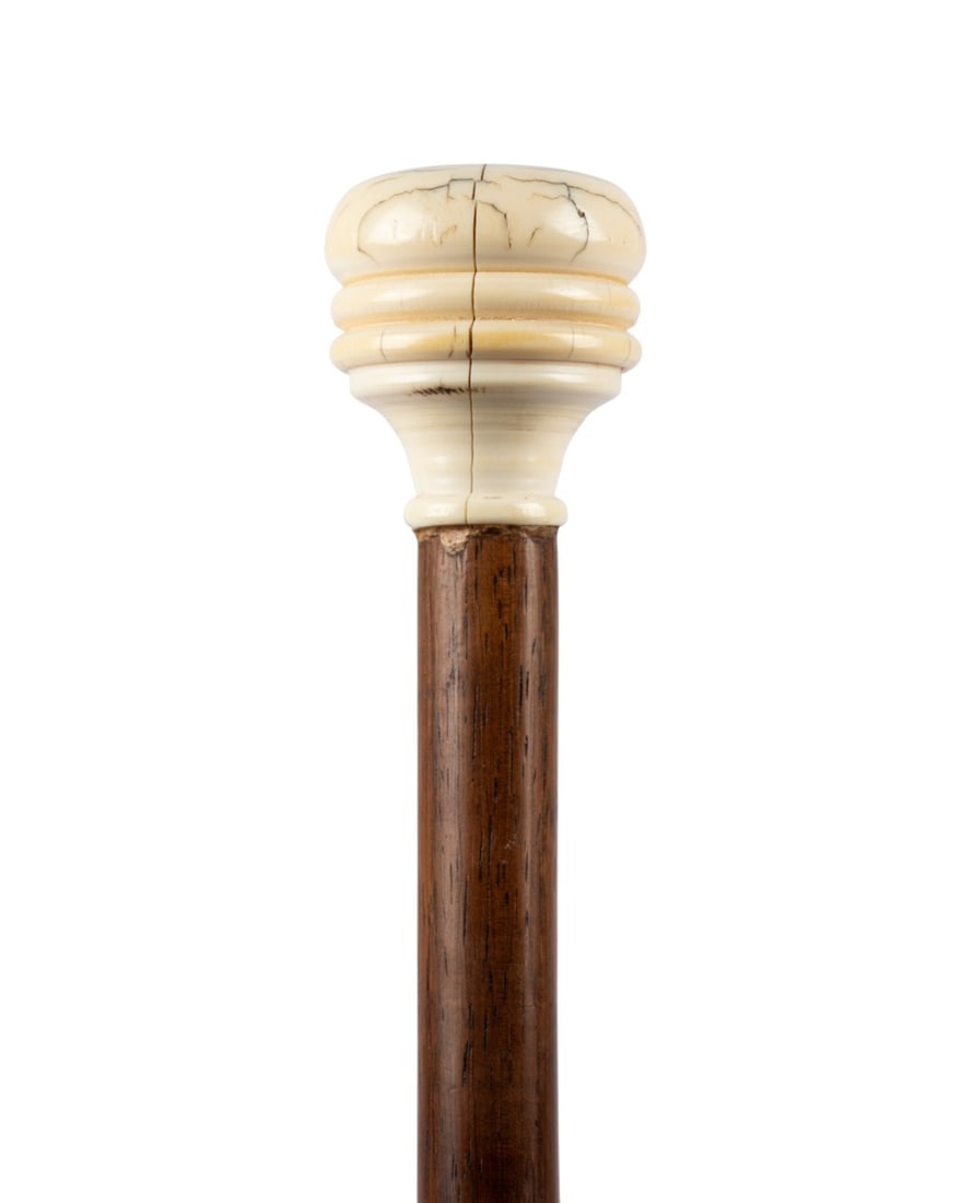 19TH C. ENGLISH TURNED KNOB HANDLED CANE: English, circa 1880. Walking cane with turned and carved handle with side decoration, stained hardwood shaft, and matching ferrule. Approximate measurements: length: 32.25"