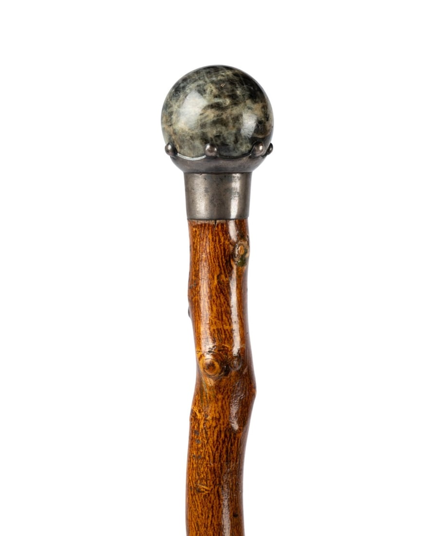 ENGLISH HARDSTONE & SILVER WALKING CANE, C. 1880: English, circa 1880. Walking cane with hardstone handle surrounded by decorative English silver collar, with natural maple wood shaft retaining nubs, and metal ferrule. Approximate measurements: lengt