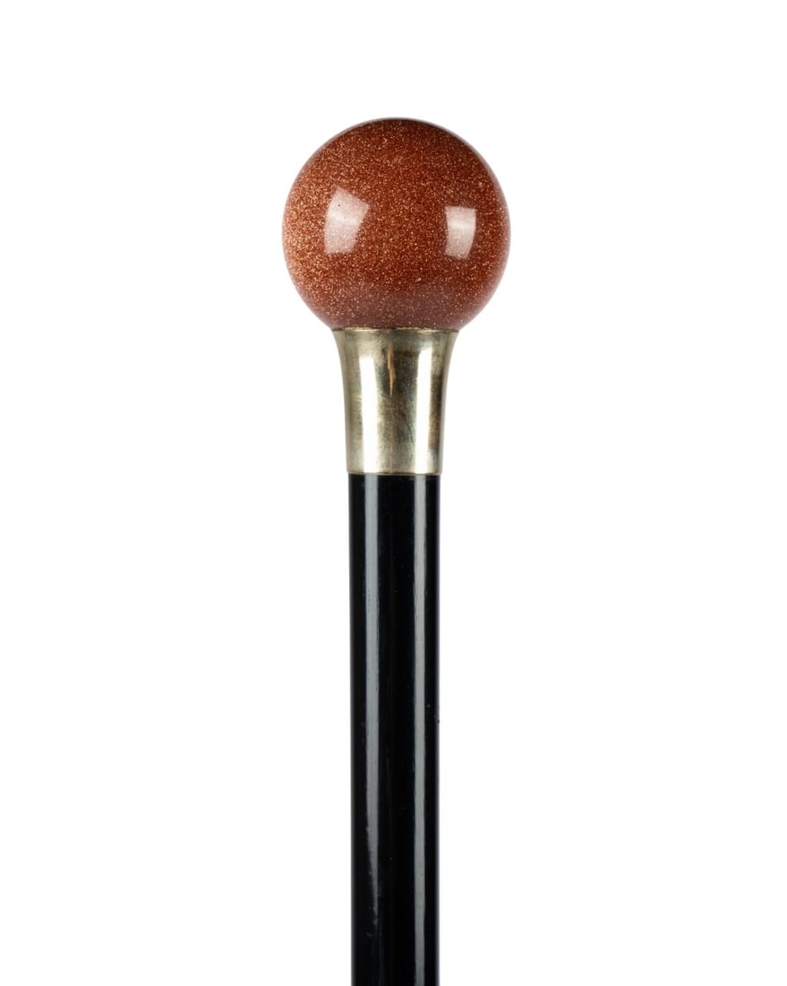 19TH C. AVENTURINE BALL HANDLE DRESS CANE: Continental, circa 1880. Dress walking cane with aventurine hardstone ball handle seated on gilt collar, with ebony shaft and black horn ferrule. Approximate measurements: length: 36"