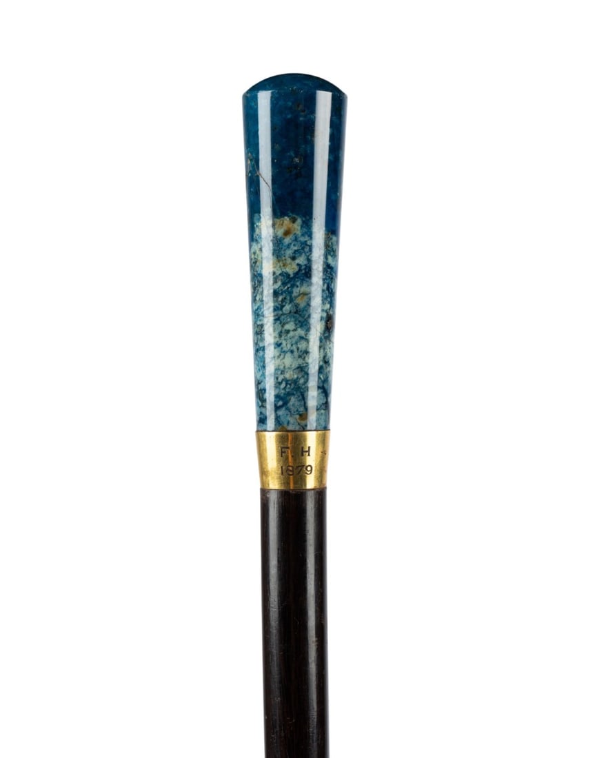 19TH C. ENGLISH LAPIS LAZULI WALKING CANE: English, circa 1879. Dress walking cane with large polished lapis lazuli handle seated on gold-colored collar engraved ?F.H. 1879,? with Macassar wood shaft and metal ferrule. Approximate measurements