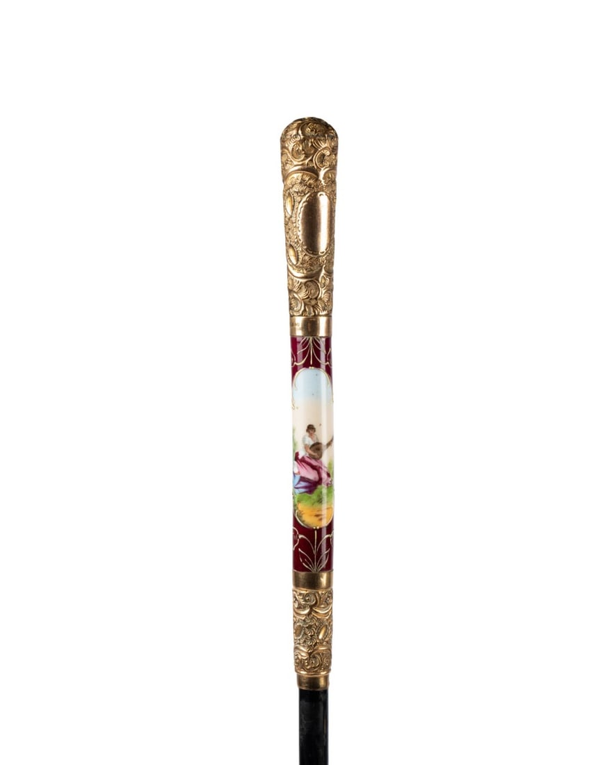 GERMAN PORCELAIN & GILT UMBRELLA HANDLE CANE: German, circa 1910. Walking cane made from umbrella handle with 18k gold-plated handle embossed at top and bottom, with porcelain center depicting a woman playing a lute on purple background with