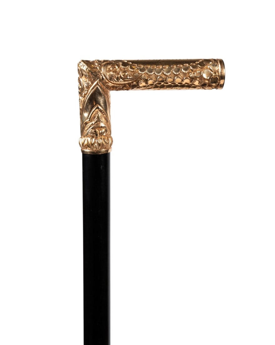 19TH C. GILT REPOUSSE HANDLE WALKING CANE: Canadian, circa 1890. Walking cane with gold-plated repousse handle inscribed ?J. Lapointe? and decorated with punch mark initials ?WDC,? with ebonized wood shaft terminating in steel, and iron ferrul