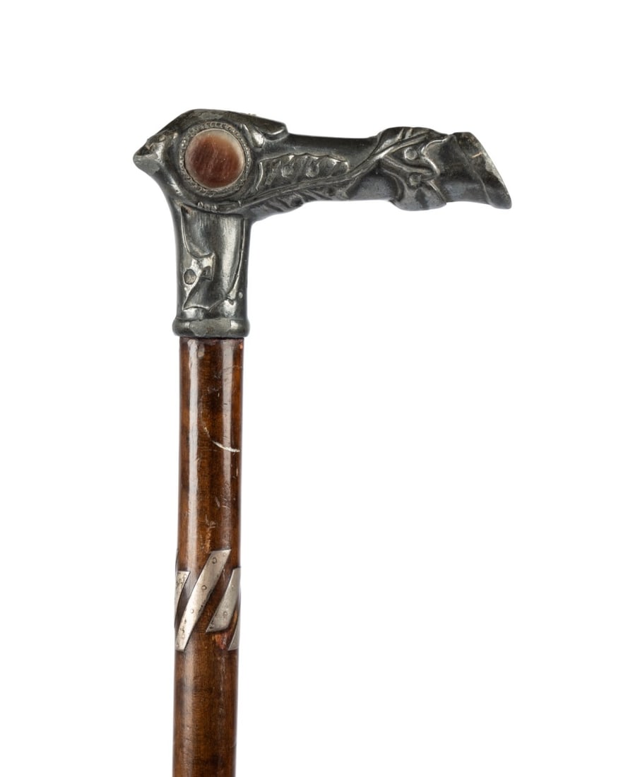 PEWTER & MOTHER OF PEARL HOOF HANDLE CANE: English, circa 1890. Walking cane with L-shaped handle modeled as horse hoof and leg, decorated with mother of pearl accents on both sides, with turned walnut shaft with six silver applied strips at t