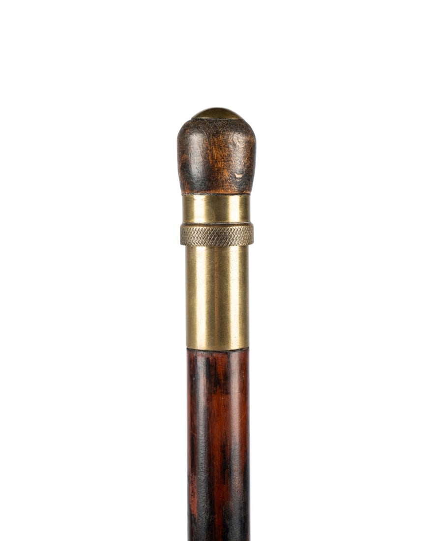19TH C. GERMAN FLAGEOLET OR FLUTE MUSICAL CANE: German, circa 1870. Flageolet walking cane with wooden knob handle capped with solid brass curved disk, solid brass collar with cross-stitch design, darkly stained mahogany shaft with brass ferrule, c