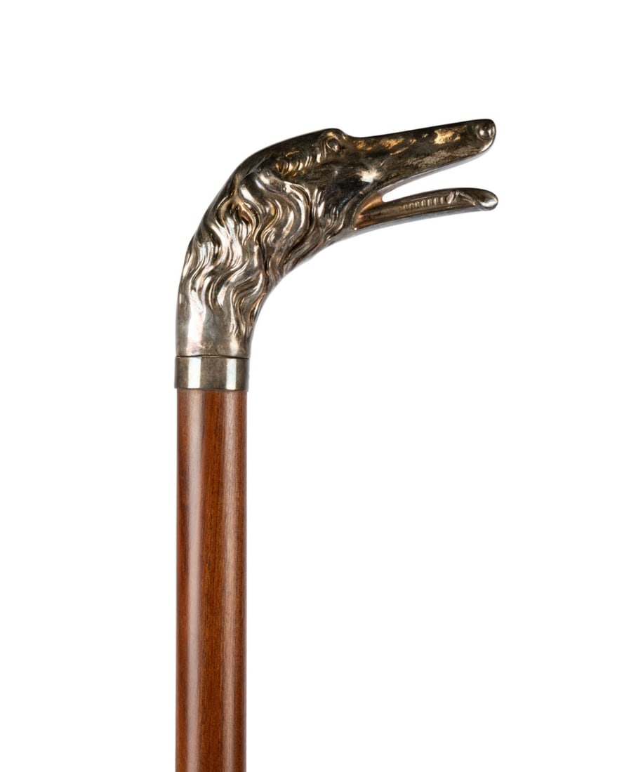 ENGLISH SILVER BORZOI HEAD HANDLE CANE, C. 1900: English, circa 1900. Walking cane with English silver bust of Borzoi dog handle and silver collar, with finely turned walnut shaft terminating in black horn ferrule. Approximate measurements: