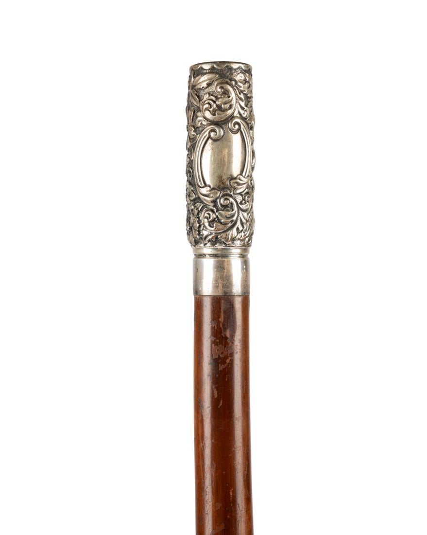 ENGLISH GORHAM STERLING SILVER WALKING CANE: English, circa 1894. Walking cane with heavily embossed sterling silver handle decorated with sunflowers and florals, with blank cartouche at center, marked ?Sterling? at base, with hardwood shaft