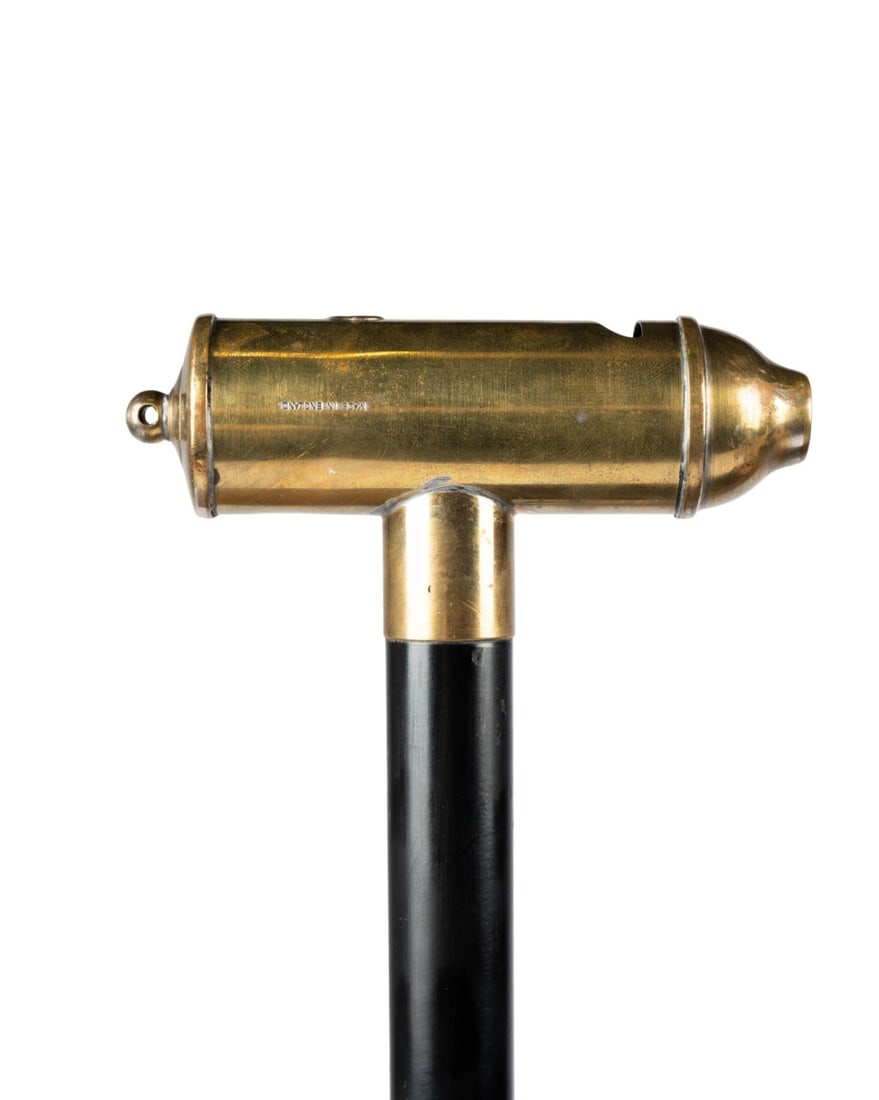 19TH C. ENGLISH BIRD WATCHER'S WHISTLE CANE: English, circa 1890. Walking cane with brass whistle-shaped handle engraved ?Made in England,? brass sleeve, ebonized hardwood shaft, and brass ferrule. Approximate measurements: length: 35.75"