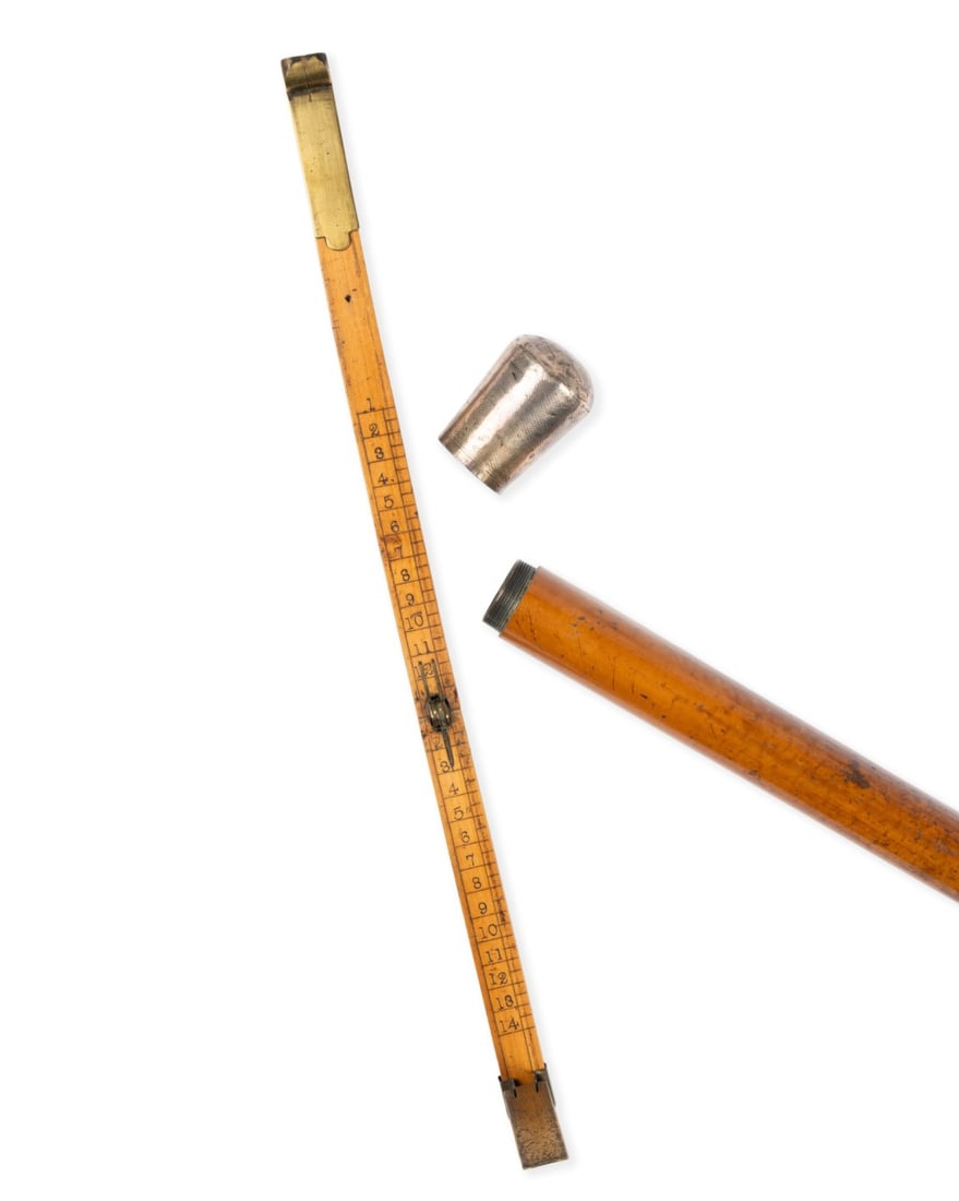 19TH C. ENGLISH SHOEMAKER'S GADGET CANE: English, circa 1890. Shoemaker’s gadget walking cane with silver knob handle unscrewing to reveal foot measuring device marked "W.J. Barron and Sons", with fruitwood shaft terminating in brass