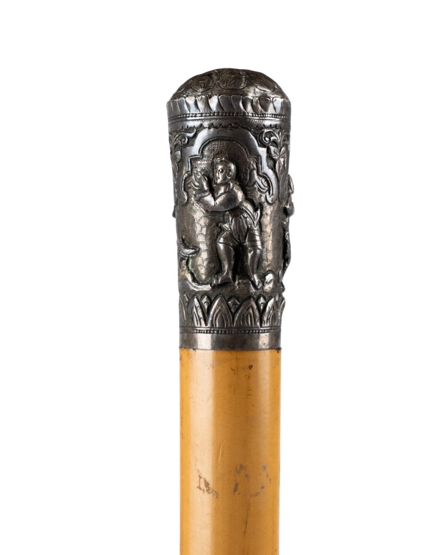 19TH C. JAPANESE TOBACCO PIPE GADGET CANE: Japanese, circa 1850. Gadget cane with mixed metal handle decorated in repousse with figures, Malacca shaft, metal ferrule, and handle unscrewing to reveal tobacco pipe concealed within the hollow sha