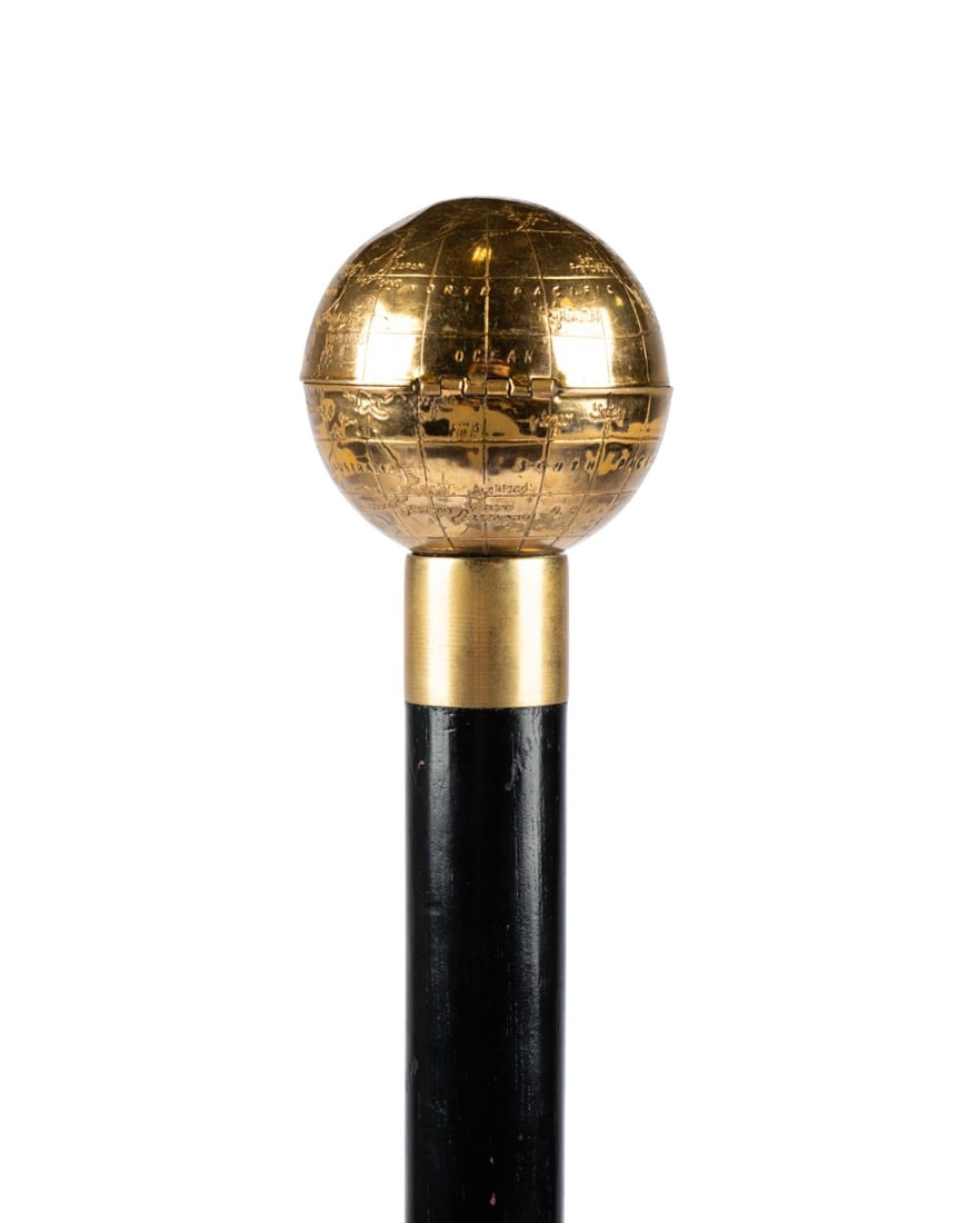 ENGLISH LADIES COMPACT CANE: English, 19th/20th century. Ladies’ walking cane with brass globe handle opening via side button to reveal white plastic compact with mirror, supported by brass collar, the mid-20th century compact