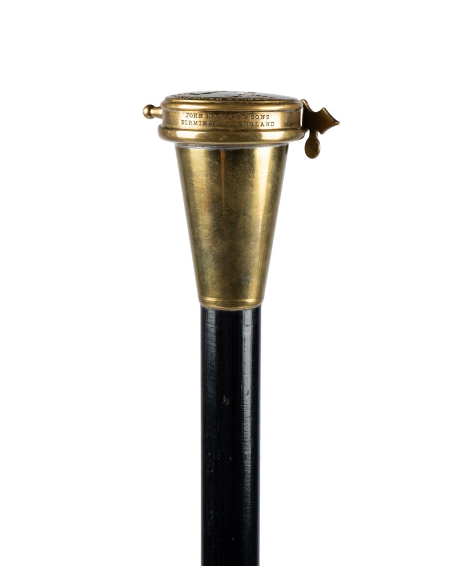 ENGLISH PILL BOX WALKING CANE, C. 1880: English, circa 1880. Walking cane with molded tapered handle with flip top pill compartment, with grained burlwood shaft terminating in bone ferrule. Approximate measurements: length: 36.75"