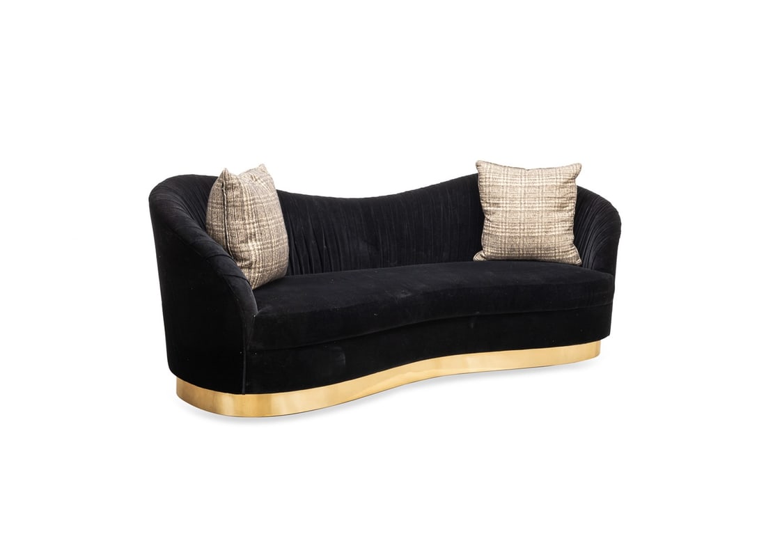 1970S MCM STYLE CAMEL BACK UPHOLSTERED SOFA: American. Mid Century Modern 1970s style kidney shaped sofa, with a camel back, black upholstery, two coordinating throw pillows and raised on a conforming gold tone foot, apparently unmarked. Provena