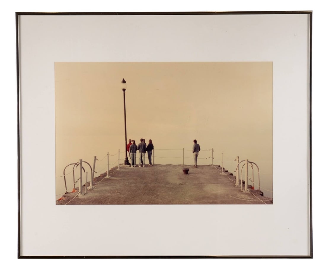 MICHAEL ZIRKLE, 'CHARLOTTE PIER I', PHOTOGRAPH: Michael Zirkle (American, 20th / 21st Century). "Charlotte Pier I" - late 20th century, C-print on paper, photograph presenting a grouping of four people to the left beside a lamppost, before a dock f