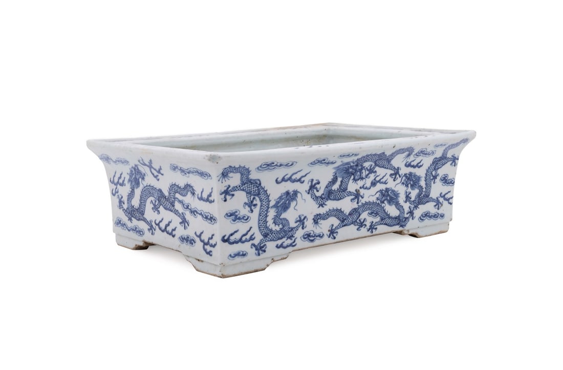 CHINESE BLUE AND WHITE DRAGON BONSAI PLANTER: Chinese, 19th century. Blue and white porcelain planter or jardiniere decorated with flying dragons among clouds, apparently unmarked. Provenance: Estate of Scott Hudgens and Jacqueline Casey