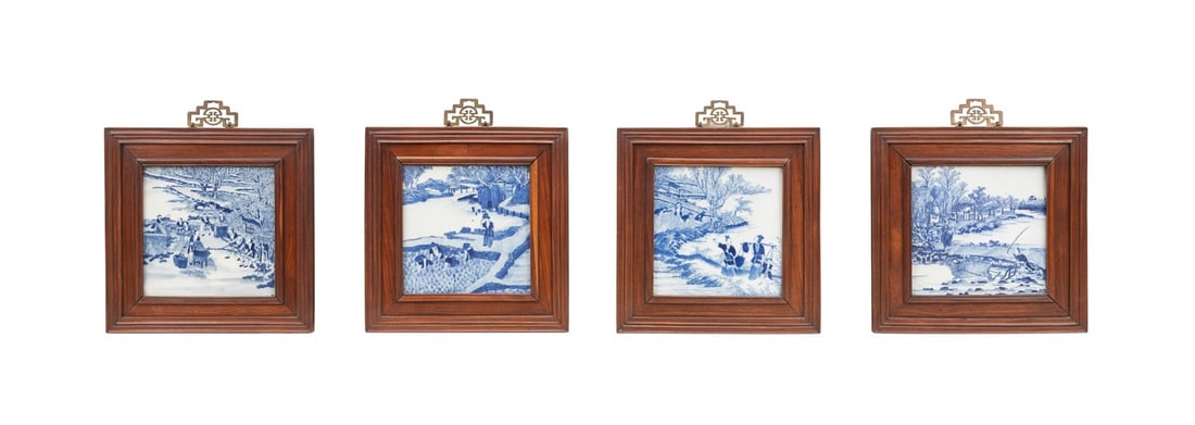 FOUR CHINESE BLUE AND WHITE FRAMED TILES: Chinese, 19th century. Group of four porcelain blue and white tiles depicting domestic village scenes of figures in daily pursuit of rice production, presented in rosewood frames with decorative brass