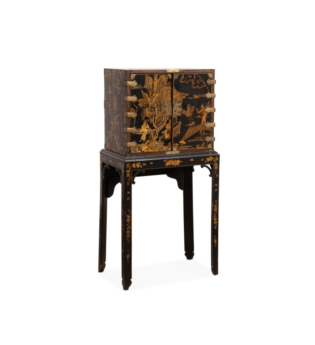 CHINESE EXPORT COLLECTOR'S CABINET ON STAND: Chinese, 19th century. Export black and brown lacquered collector's cabinet, having figural gilt decoration, double doors, 11-drawers, and rising on an associated chinoiserie decorated stand with stra