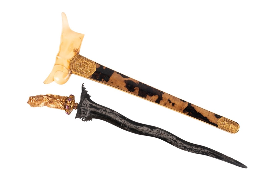 BALINESE CARVED BONE AND GOLD KRIS DAGGER: Southeast Asian, 20th century. Balinese gold wrapped Kris / Keris carved bone anthropomorphic deity hilt, ruby and sapphire cabochon mounted selut, and having a gold sheathed chased scabbard. Provenan