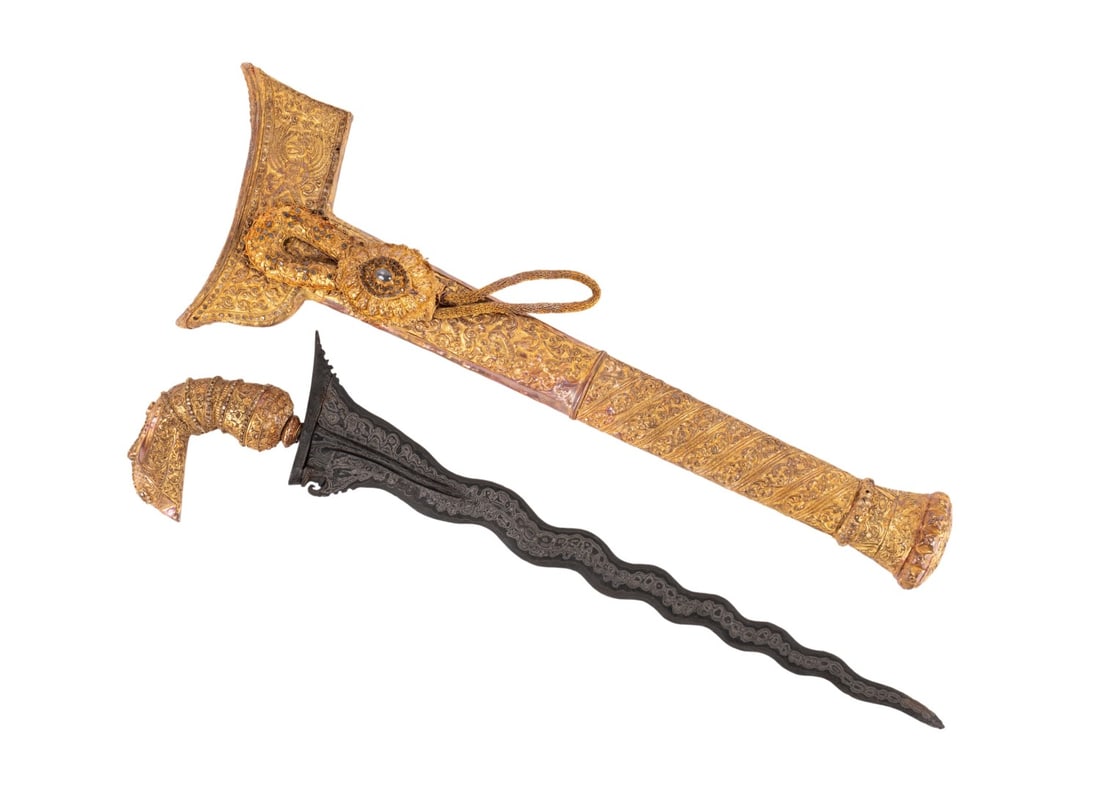 INDONESIAN GEM MOUNTED & GOLD ENCASED KRIS: Southeast Asian, 20th century. Indonesian diamond and sapphire mounted gilt Kris / Keris having a stylized bird "Garuda" hilt, gold sheathed scabbard, with a sapphire and diamond set toli-toli-- attac