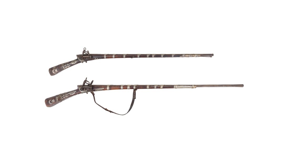 TWO TURKISH LONG GUNS, BULGARIAN MIQUELET LOCKS: Ottoman / Turkish, 19th century. Two long guns or rifles (tufek) with Bulgarian miquelet locks, carved shishane stocks, applied silver star, moon, and cartouche form decoration; and the barrels