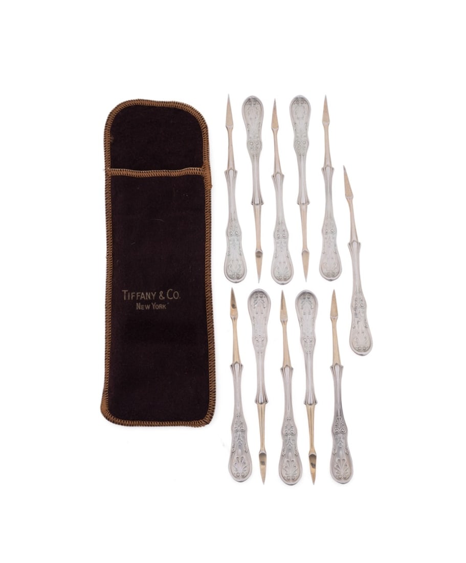 TIFFANY & CO., 11 'SARATOGA' STERLING NUT PICKS: Tiffany & Co. (American, founded 1837), late 19th to early 20th century. Set of 11 sterling silver and gold washed "Saratoga" (pattern introduced 1870) nut picks, all appropriately marked. Approximate
