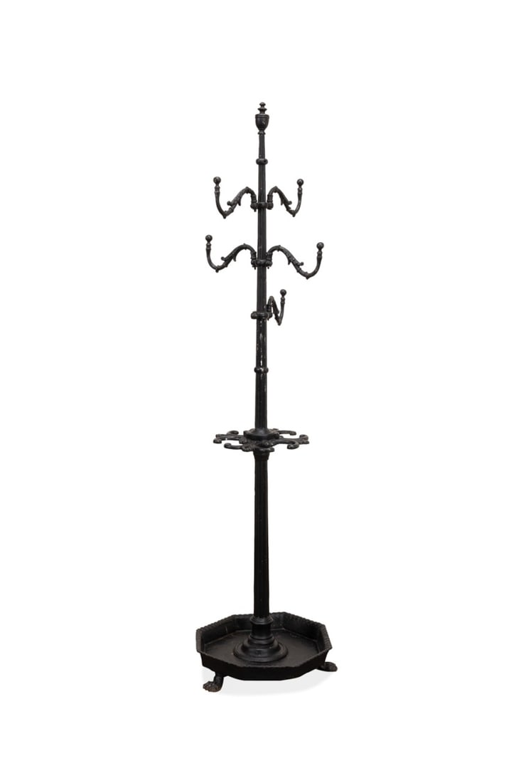 19TH C. ENGLISH VICTORIAN CAST IRON COAT RACK: English, 19th century. Victorian era cast iron coat and umbrella stand, having 5-hooks, four holders for umbrellas or walking sticks, and rising on paw feet, apparently unmarked. Provenance: Estate of