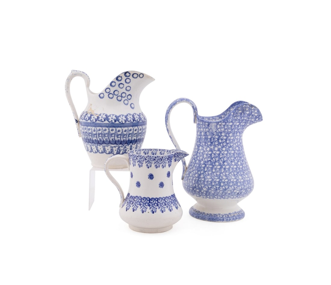 THREE ENGLISH SPONGEWARE POTTERY PITCHERS: English, 19th century. Group of three blue and white Staffordshire style pitchers, spongeware or calico decorations, apparently unmarked. Provenance: Estate of Scott Hudgens and Jacqueline Casey Hudge
