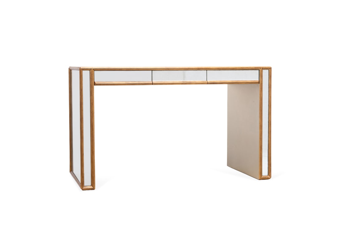 JULIAN CHICHESTER, MIRRORED & GILT 3-DRAWER DESK: Julian Chichester (English, founded 1989), circa 2006. Hollywood Regency style mirrored and gilt edge desk or table having three front drawers, label with maker's mark and date to upper side corner. A