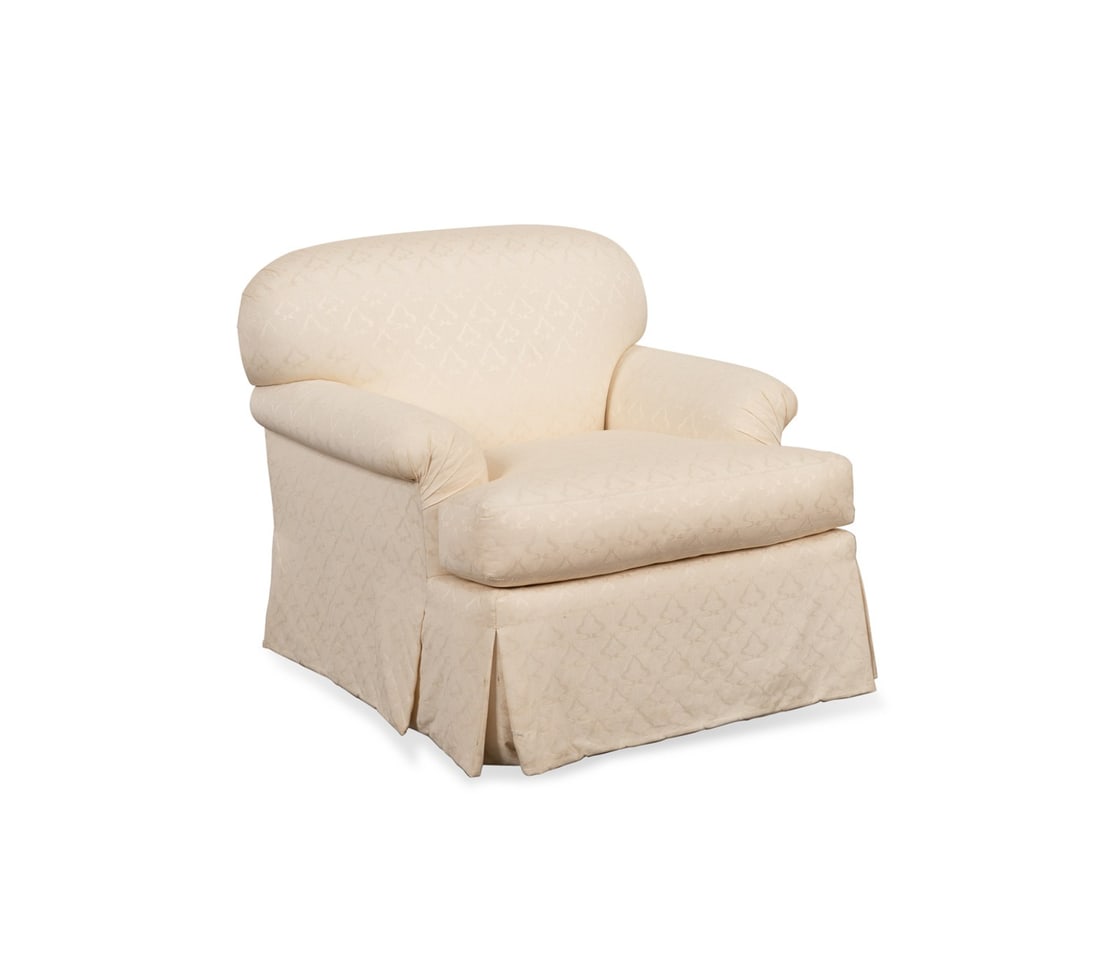 R. JONES CREAM UPHOLSTERED CLUB CHAIR: R. Jones & Associates (American, founded 1980), late 20th to early 21st century. Cream upholstered club chair, having a curved back and arms, loose seat cushion, and box pleated shirt, appropriately m