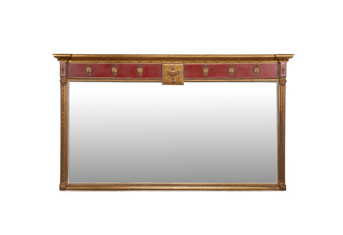 OVERSIZED CUSTOM REGENCY STYLE OVERMANTEL MIRROR: American, late 20th to early 21st century. Oversized custom parcel gilt wooden and composition overmantel mirror in the Regency taste, having a shaped cornice with spheres, red painted frieze with Cla