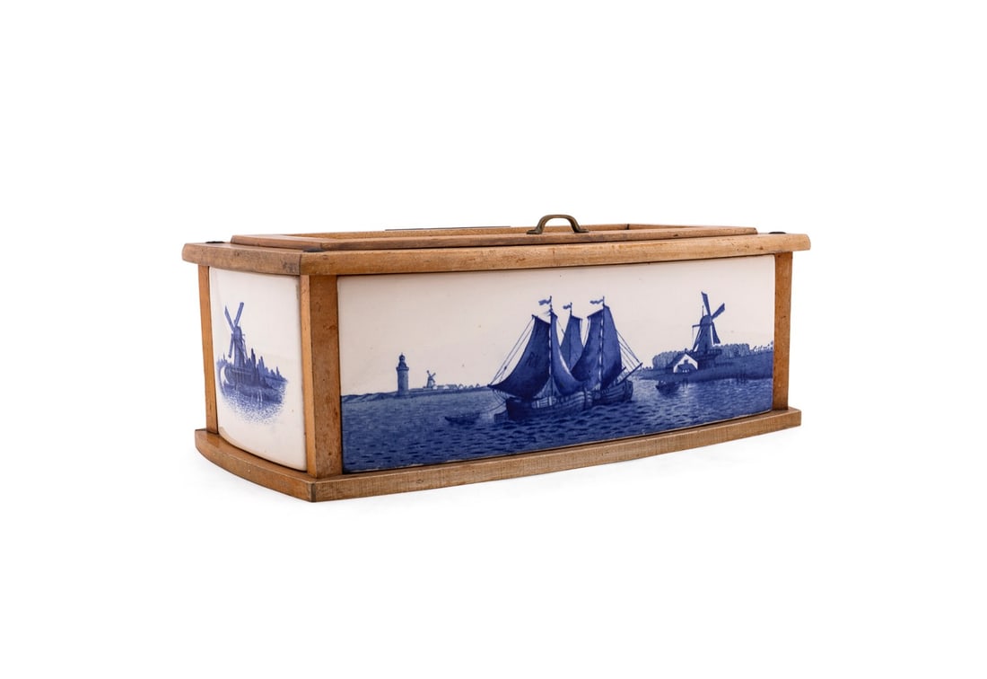 VILLEROY & BOCH DELFT STYLE TILE BREAD BOX: Villeroy & Boch (German, found 1836), late 19th / early 20th century. Blue and white breadbox with transfer printed delft style tiles showing harbor scenes in a maple frame box with lift top, marked