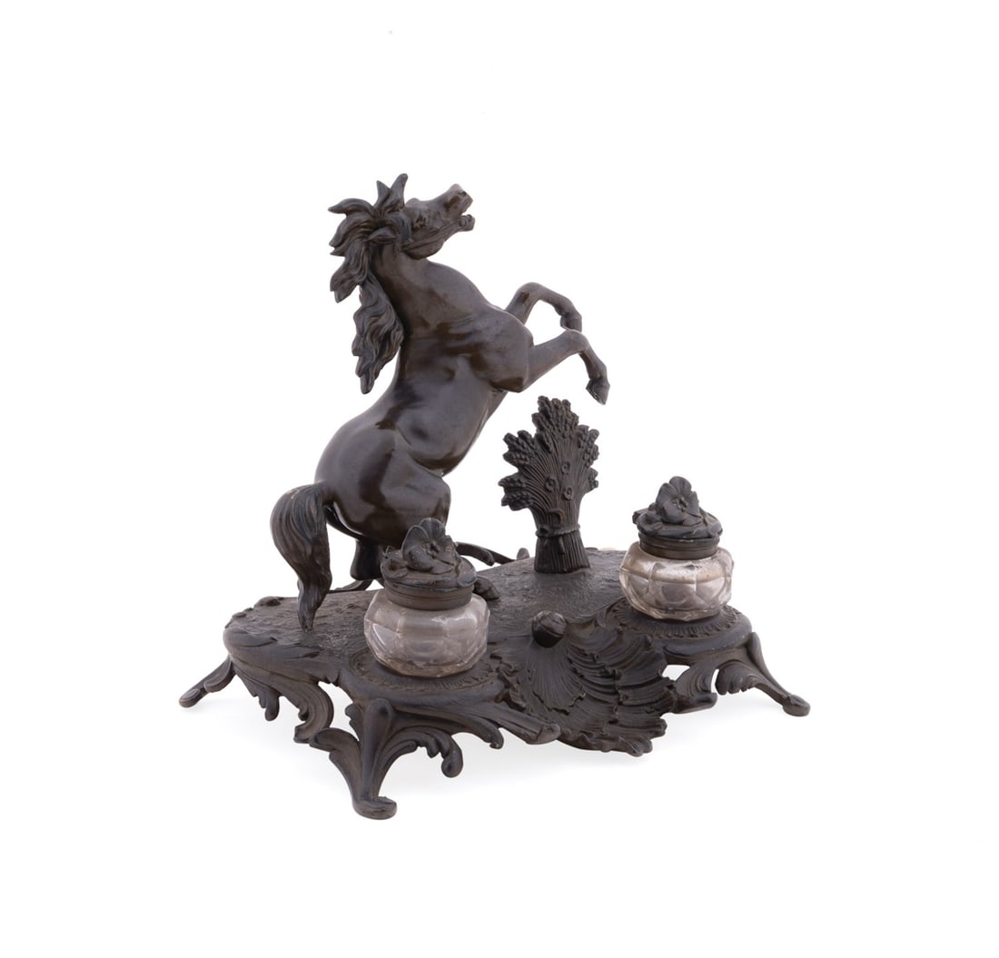PATINATED SPELTER EQUESTRIAN MOTIF INKSTAND: Continental, likely French, early 20th century. Patinated spelter equestrian motif inkstand modeled in part after the Marley Horses, having a rearing horse, two inkwells, and rising on a Rococo style