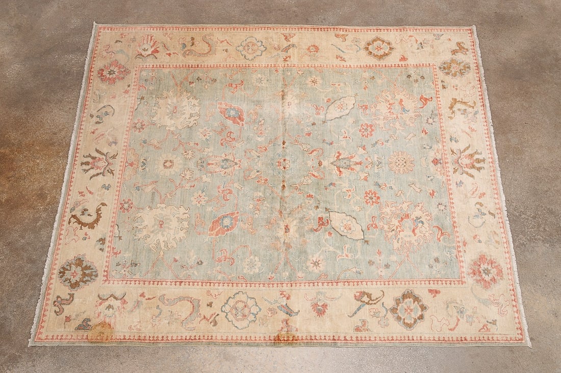TURKISH 20TH C. HANDWOVEN PASTEL TONE OUSHAK RUG: Turkish, 20th century. Handwoven pastel tone Oushak rug having a light blue field with beige border and pink and brown accents. Approximate dimensions: l. 9' 4", w. 8'.