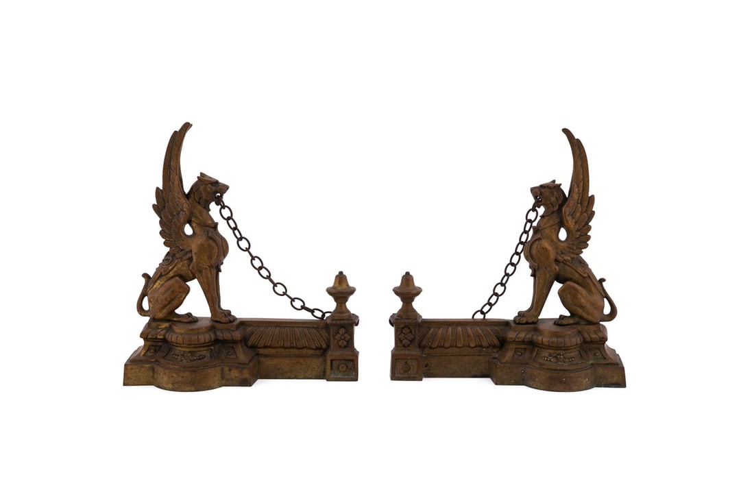 PR. OF HERALDIC GRIFFIN BRONZE FIREPLACE ORNAMENTS: Continental, late 19th to early 20th century. Pair of gilt bronze fireplace ornaments, formerly part of a fender, in the Renaissance taste, each modeled as an chained heraldic griffin, both apparently