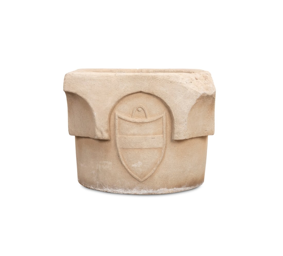 CARVED STONE RENAISSANCE STYLE WELLHEAD PLANTER: Continental, 19th / 20th century. Large carved stone garden planter modeled as an early Renaissance distressed wellhead, having an heraldic shield, apparently unmarked. Approximate dimensions: h. 25",