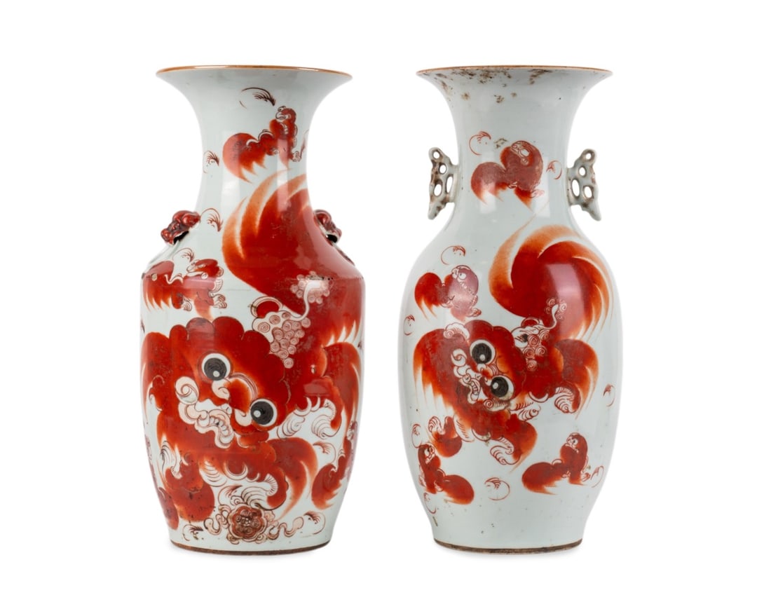 PAIR OF CHINESE IRON-RED BUDDHIST LION VASES: Chinese, early 20th century. Pair of porcelain vases decorated with iron-red Buddhist lions, male, female and cubs with poetic inscription, and lion-head side handles with rings, apparently unmarked.