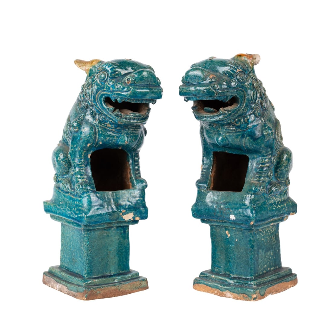 PAIR CHINESE POTTERY GUARDIAN LIONS: Chinese, 19th century. Pair of turquoise glazed guardian lions with open compartment, perched on stepped bases, apparently unmarked. Approximate dimensions: h. 13.5", w. 4.5", d. 9.5".