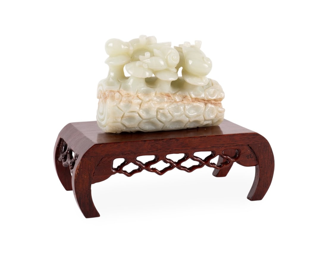 CHINESE JADEITE CARVING, FUNGI ON LOG WITH SNAIL: Chinese, 20th century. Pale green jade carving of mushrooms growing on a log with snails, with wooden stand, apparently unmarked. Provenance: Private Collection of Jared M Kramer, Cartersville, GA. Ap