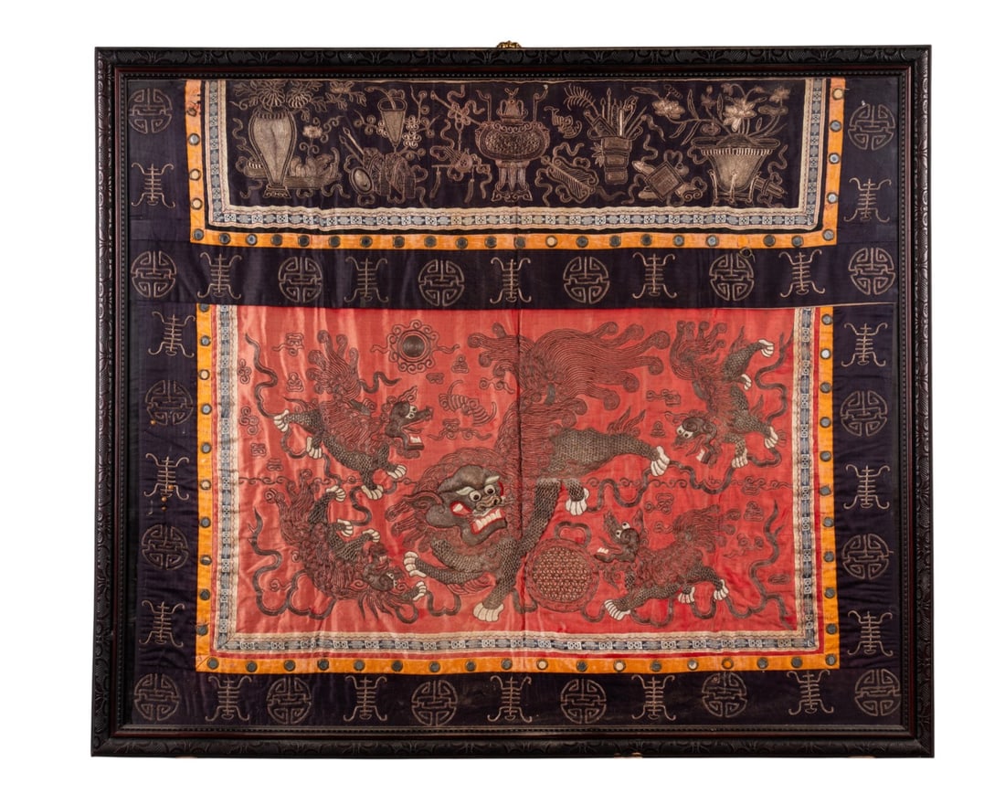 19TH C. CHINESE SILK EMBROIDERY PANEL: Chinese, 19th century. Red silk panel embroidered with metallic gold threads of fierce foo dogs at play among Buddhist flowing ribbons and reticulated balls, bordered in dark purple silk with gold Kan