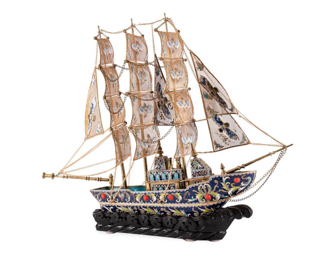 CHINESE CLOISONNE SAILING SHIP SCULPTURE: Chinese, 20th century. Cloisonne enameled and gilt metal sailing ship sculpture having blue enamel base with floral design and red cabochon stone inlays and filigree sails depicting colorful bird moti